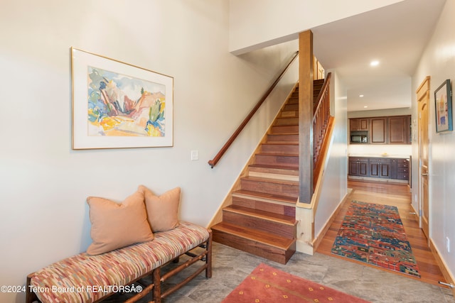 staircase with hardwood / wood-style floors