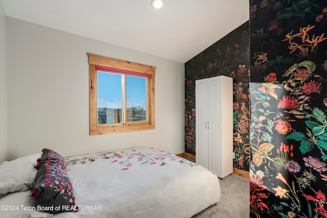 carpeted bedroom featuring lofted ceiling