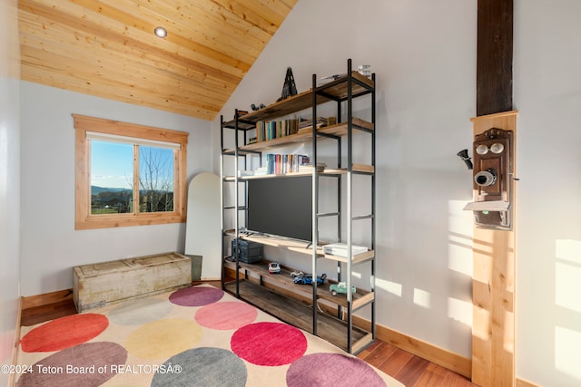 sitting room with wood-type flooring, wood ceiling, and vaulted ceiling