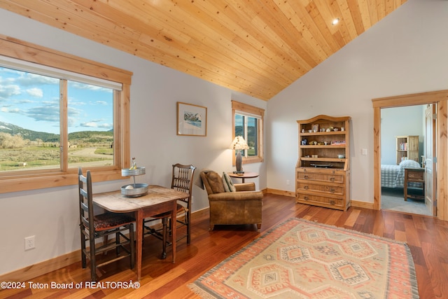 dining space featuring wood ceiling, high vaulted ceiling, and hardwood / wood-style flooring