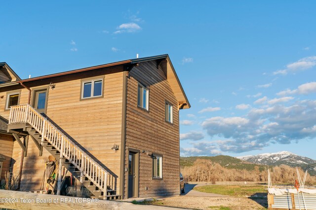 rear view of house featuring a mountain view