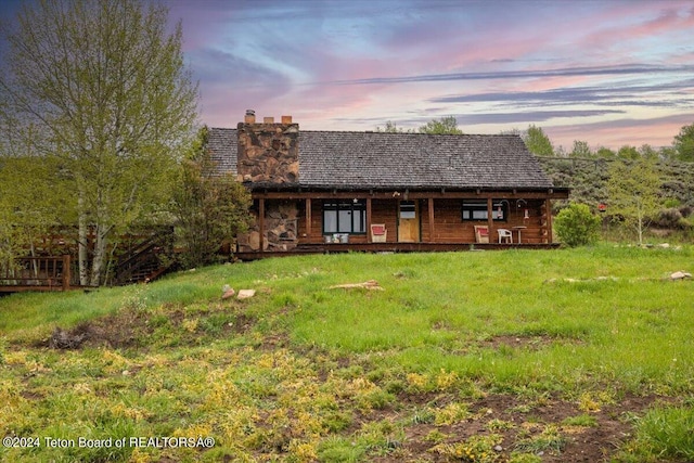 back house at dusk with a yard