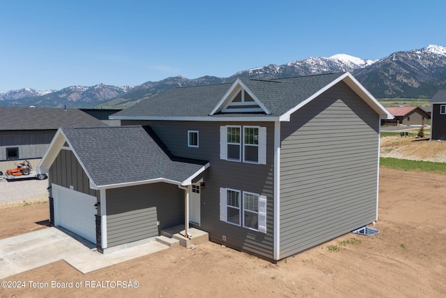 view of front of property with a mountain view and a garage