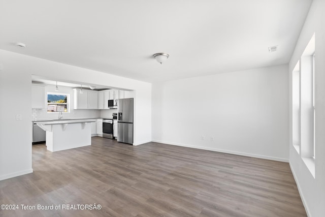 unfurnished living room featuring hardwood / wood-style flooring