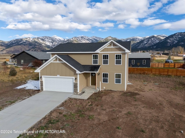 view of front facade with a mountain view and a garage