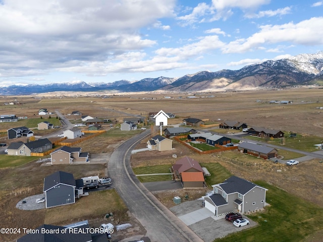 birds eye view of property with a mountain view