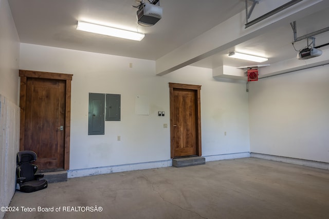 garage featuring electric panel and a garage door opener