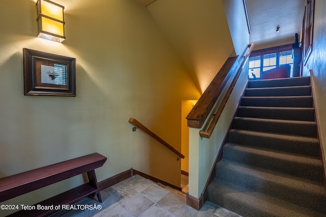 stairway with tile patterned flooring