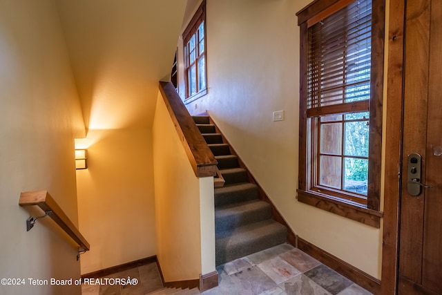 stairway with tile patterned flooring