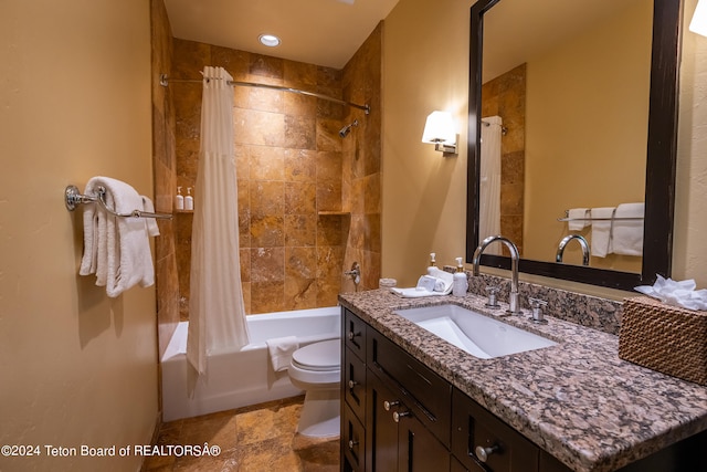 full bathroom with shower / tub combo with curtain, vanity, tile patterned floors, and toilet