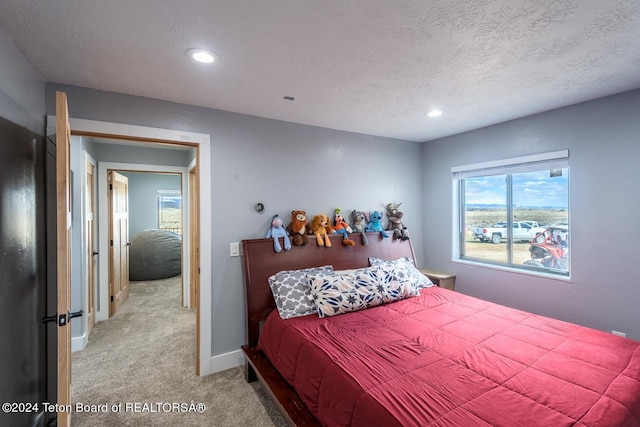 carpeted bedroom featuring a textured ceiling