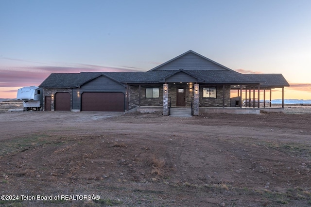 view of front of property featuring a garage and a porch