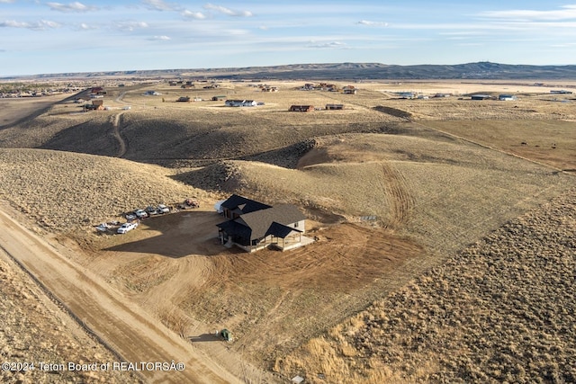 birds eye view of property with a mountain view and a rural view