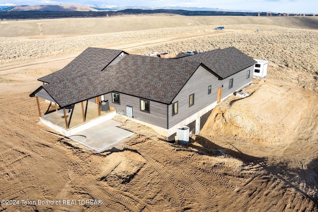 birds eye view of property with a mountain view