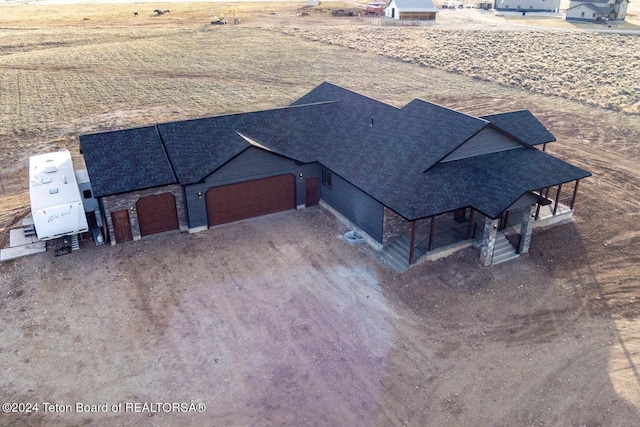 birds eye view of property with a rural view