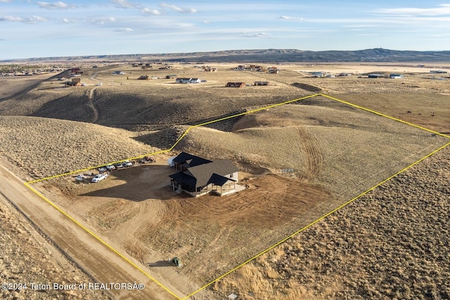 drone / aerial view featuring a mountain view and a rural view