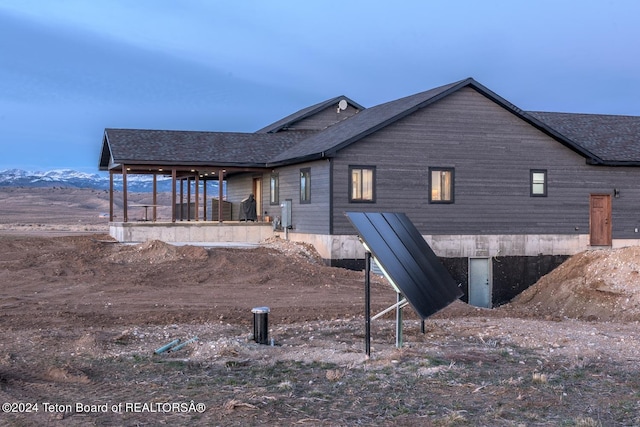 rear view of property featuring a mountain view