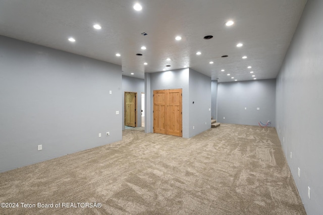 unfurnished room featuring light colored carpet