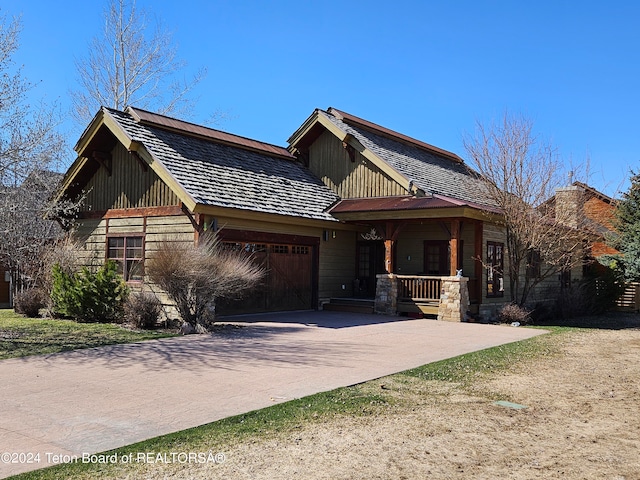 view of front of property with a porch and a garage