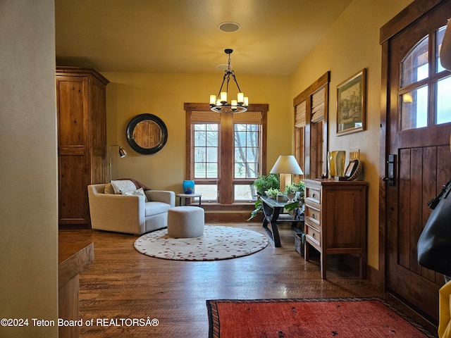 entryway featuring dark wood-type flooring and a notable chandelier