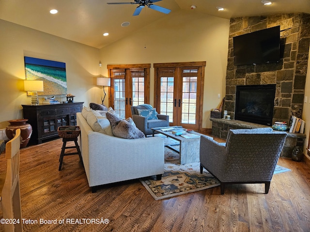 living room with hardwood / wood-style floors, a fireplace, french doors, high vaulted ceiling, and ceiling fan