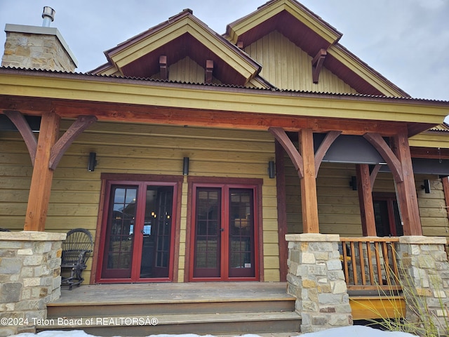 property entrance with a porch and french doors