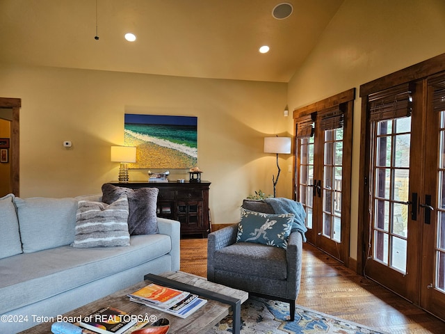 living room with a healthy amount of sunlight, vaulted ceiling, french doors, and wood-type flooring