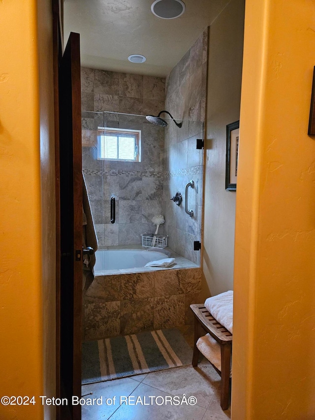 bathroom featuring tile patterned flooring and tiled bath