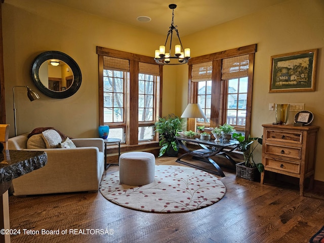 sitting room featuring wood-type flooring and a notable chandelier