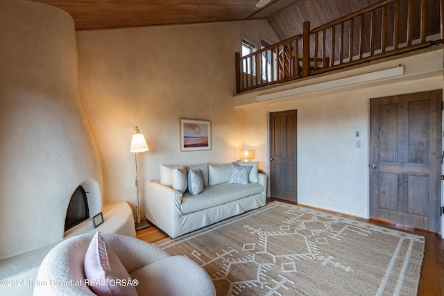 living room with high vaulted ceiling, wood ceiling, and hardwood / wood-style floors