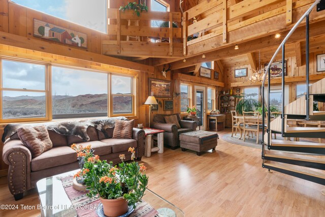 581 E Fork Rd, Dubois, WY 82513 - living area with a towering ceiling, wood walls, wood finished floors, and a mountain view