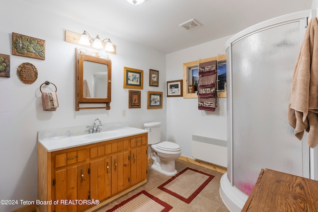 581 E Fork Rd, Dubois, WY 82513 - full bathroom with radiator heating unit, vanity, a shower stall, and tile patterned flooring