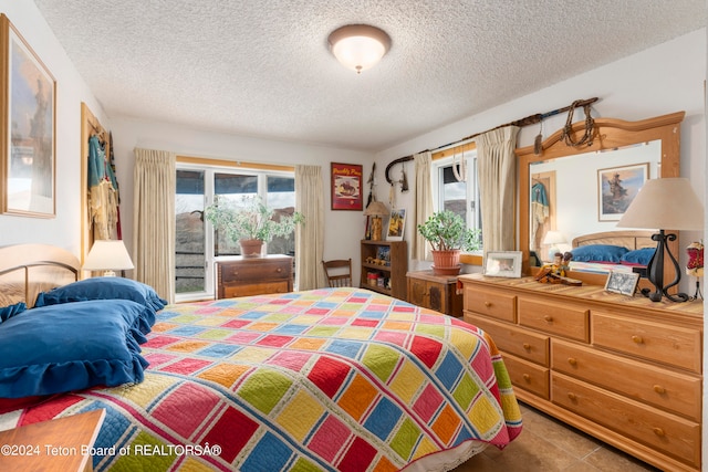 581 E Fork Rd, Dubois, WY 82513 - bedroom featuring a textured ceiling and access to outside