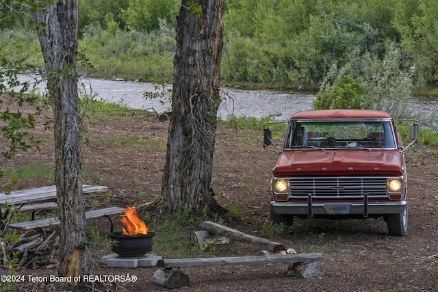581 E Fork Rd, Dubois, WY 82513 - view of yard with an outdoor fire pit, a water view, and a view of trees