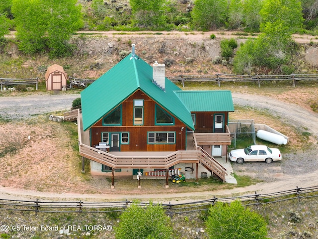 581 E Fork Rd, Dubois, WY 82513 - back of property featuring a storage shed, a metal roof, a chimney, and stairway