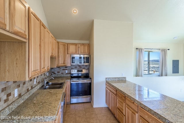 kitchen with backsplash, appliances with stainless steel finishes, light tile floors, and sink