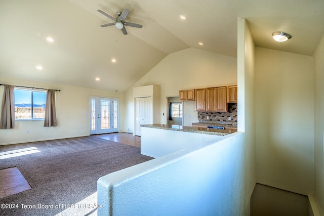 carpeted living room featuring high vaulted ceiling and ceiling fan