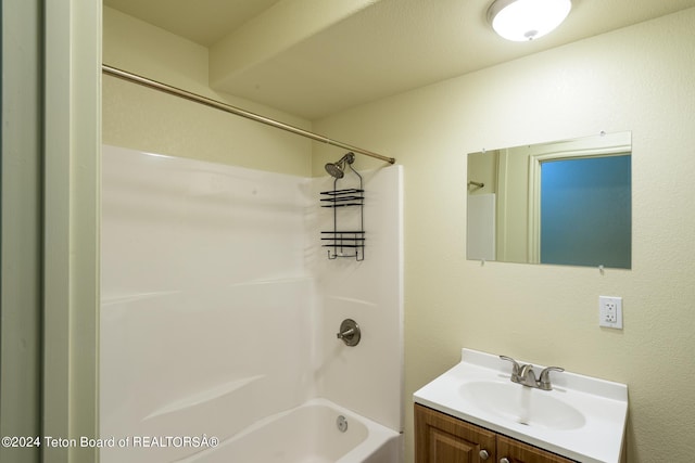 bathroom featuring shower / tub combination and vanity