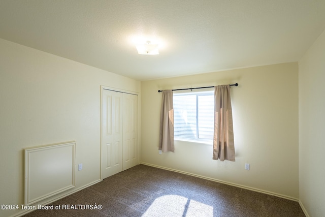 unfurnished bedroom featuring a closet and carpet floors