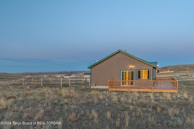 back of house featuring a wooden deck