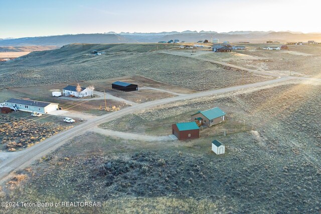 birds eye view of property with a rural view