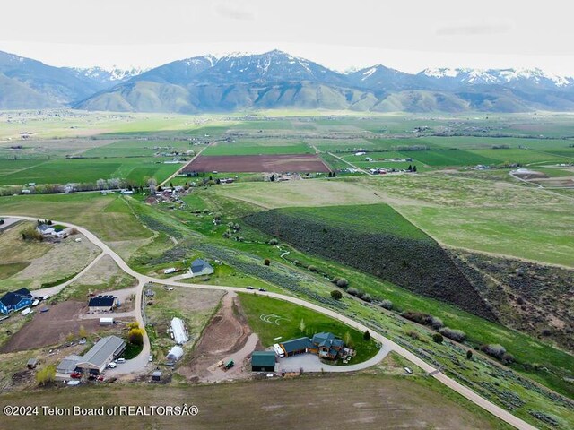 drone / aerial view featuring a mountain view and a rural view