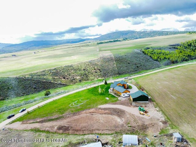 birds eye view of property with a rural view and a mountain view