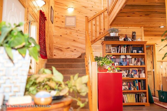 room details featuring wood walls and wood-type flooring