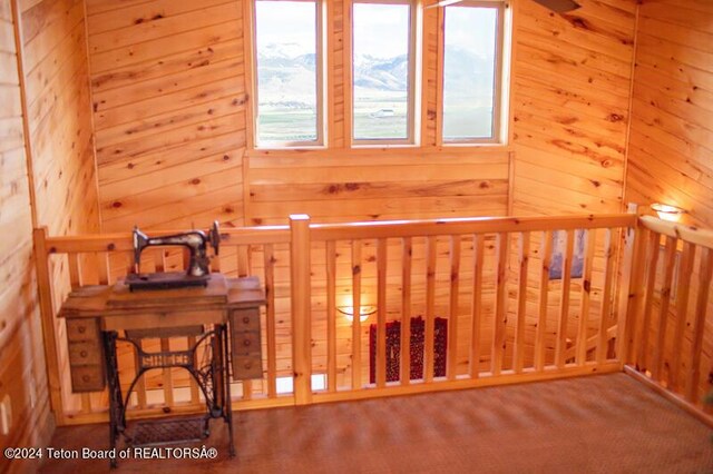 interior space featuring carpet flooring and wood walls