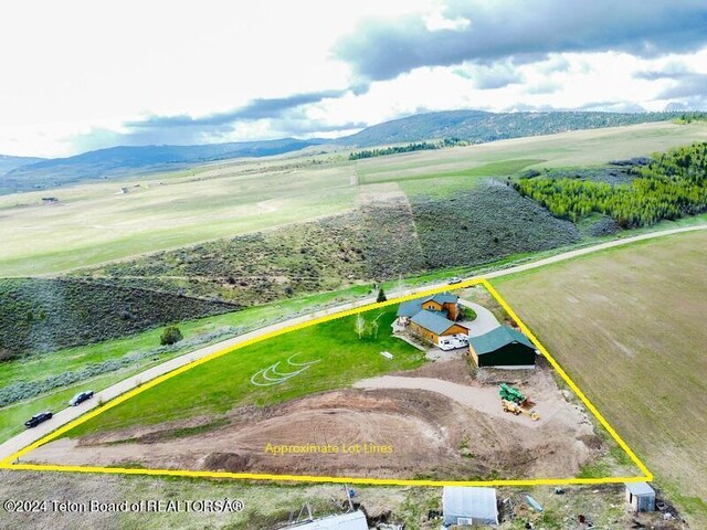 birds eye view of property with a mountain view and a rural view