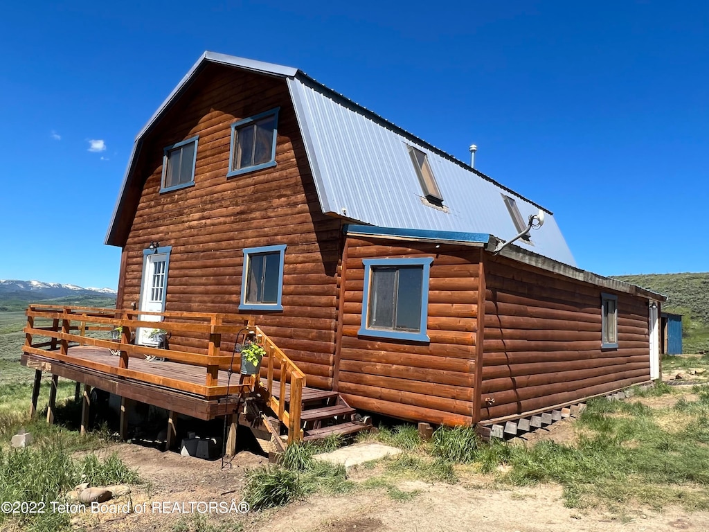 rear view of house with a deck