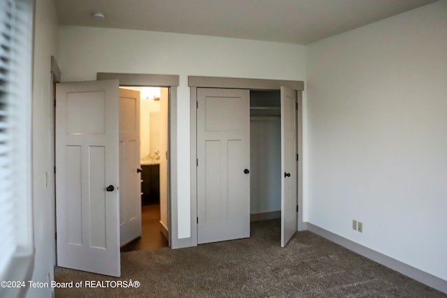 unfurnished bedroom with carpet floors and a closet