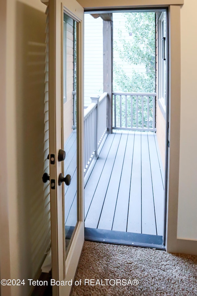 doorway with hardwood / wood-style flooring