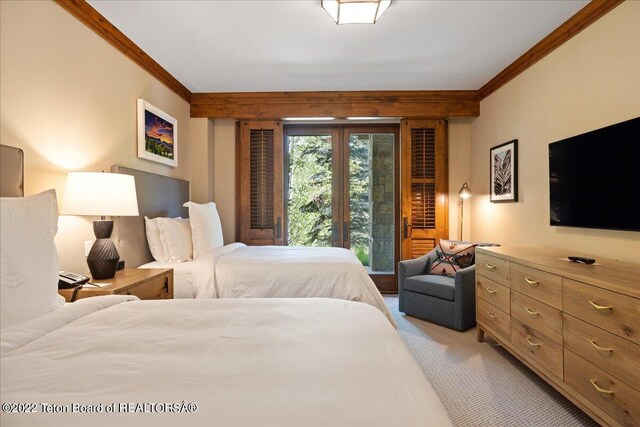 carpeted bedroom with crown molding and french doors